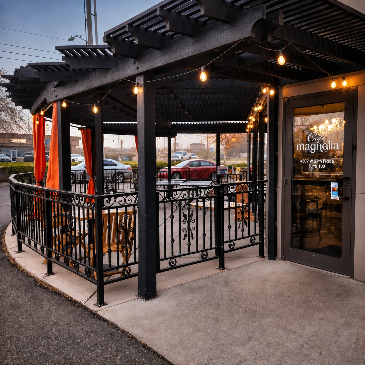 The string-lit covered patio and entrance of Café Magnolia at dusk