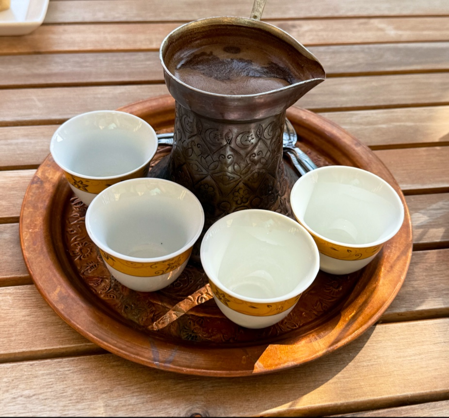 Traditional European coffee served in a brass pot with small cups at Café Magnolia